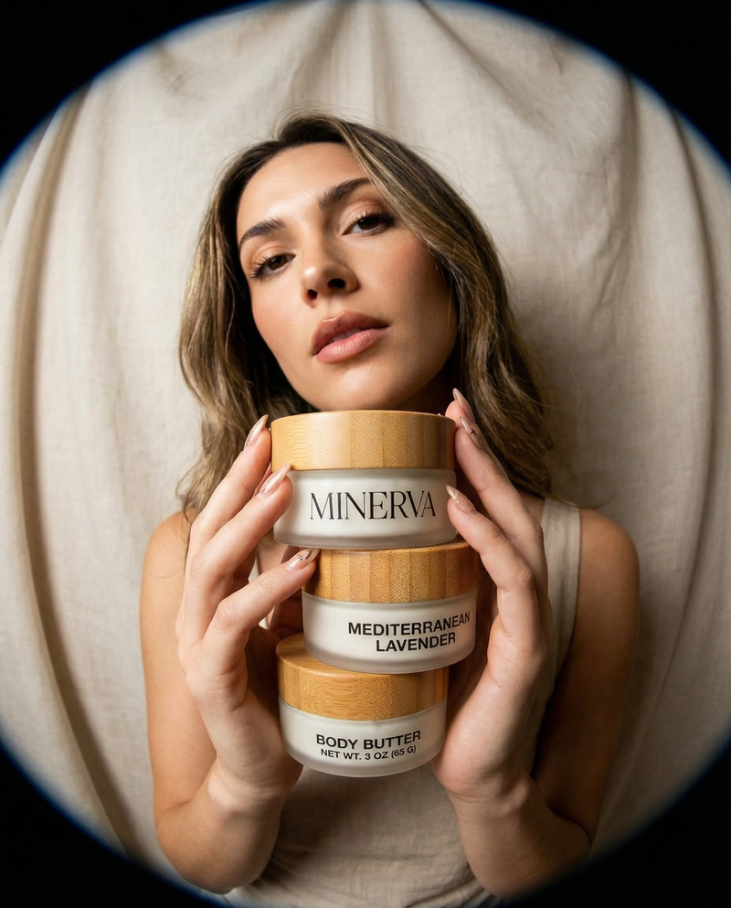 Woman holding three Minerva body butter jars against a neutral background
