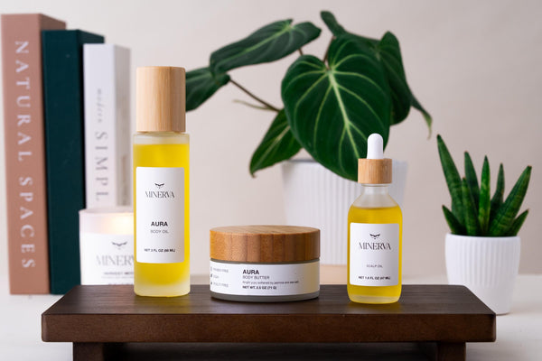 The Minerva body care set on a wooden tray with plants and books