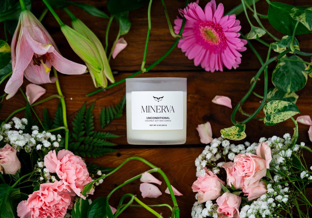 Minerva Unconditional rose and peony candle among pink lilies, gerberas and carnations